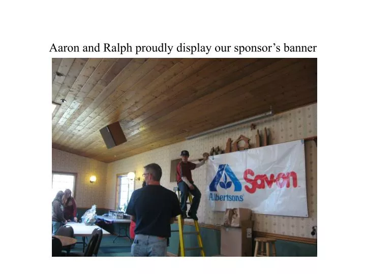 aaron and ralph proudly display our sponsor s banner